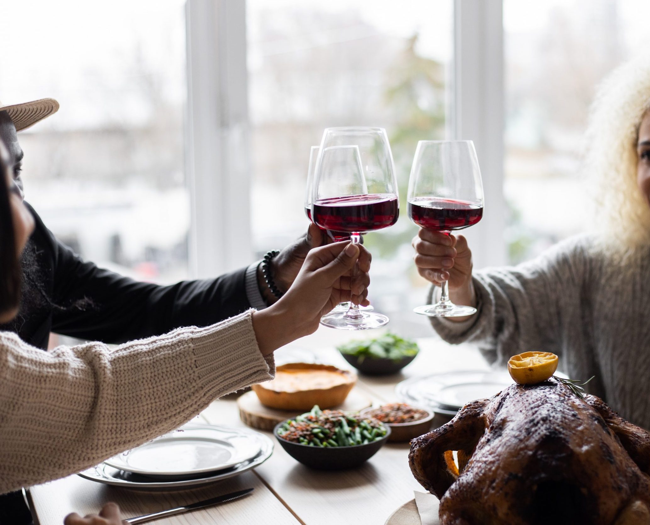 friends drinking red wine on christmas