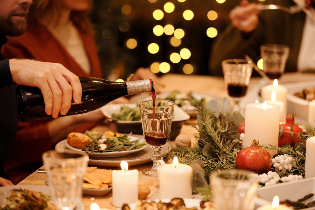 pouring red wine at a holiday dinner
