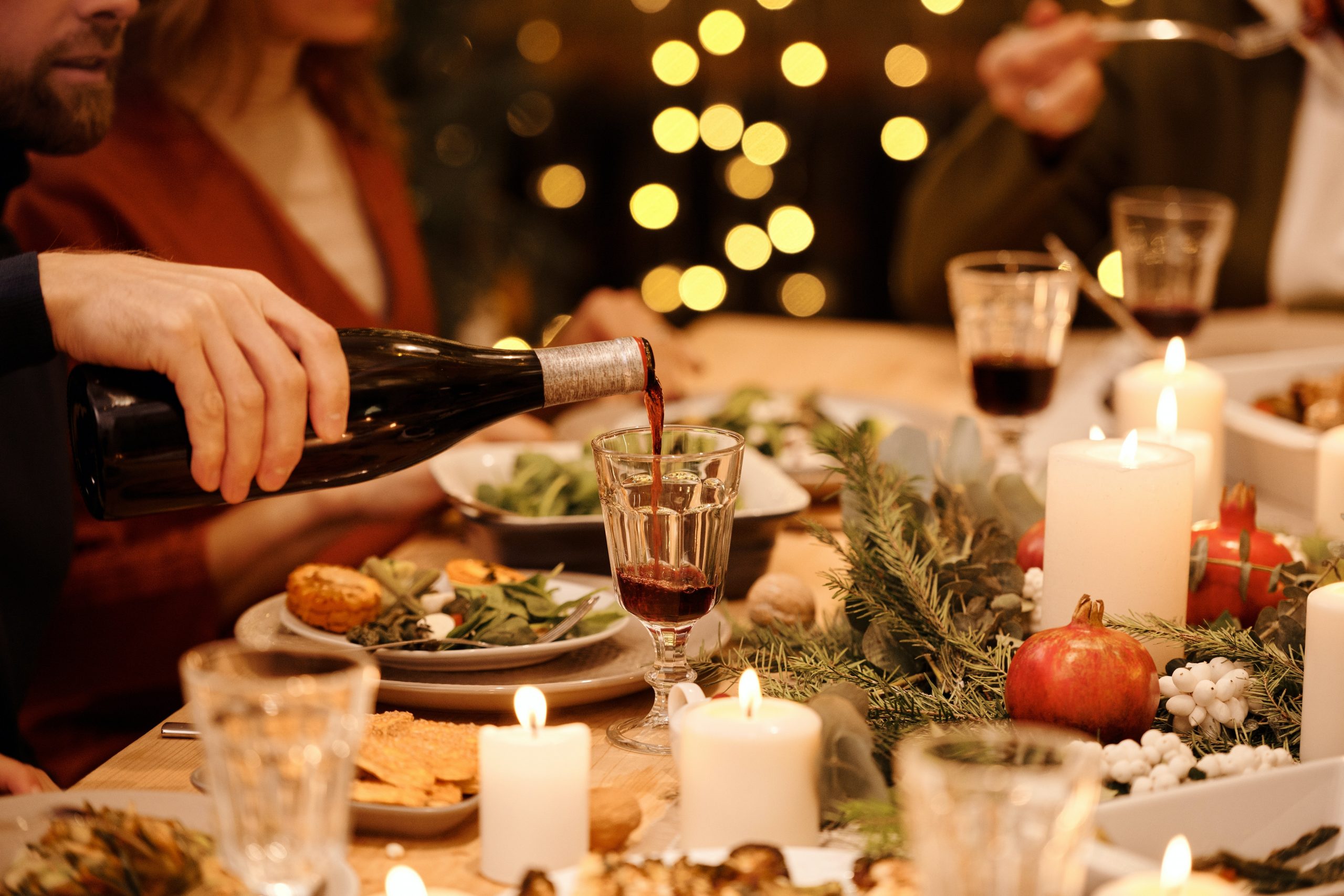 pouring red wine at a holiday dinner