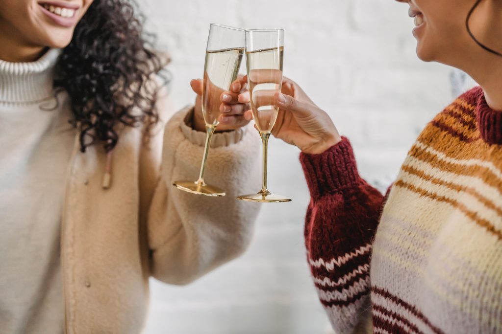 champagne cheers in cozy sweaters